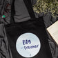 Black tote bag with 'Big Day Dreamer' text on a dark fabric background