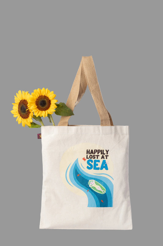 Tote bag with 'Happily Lost at Sea' design  on a white background