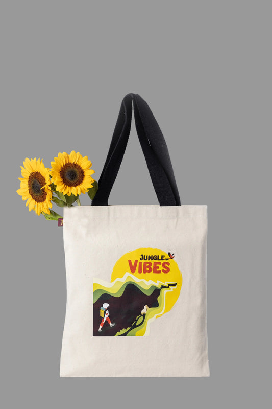 Tote bag with 'Jungle Vibes' design and sunflowers on a light gray background