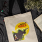 Beige tote bag with 'Jungle Vibes' design on a dark fabric background